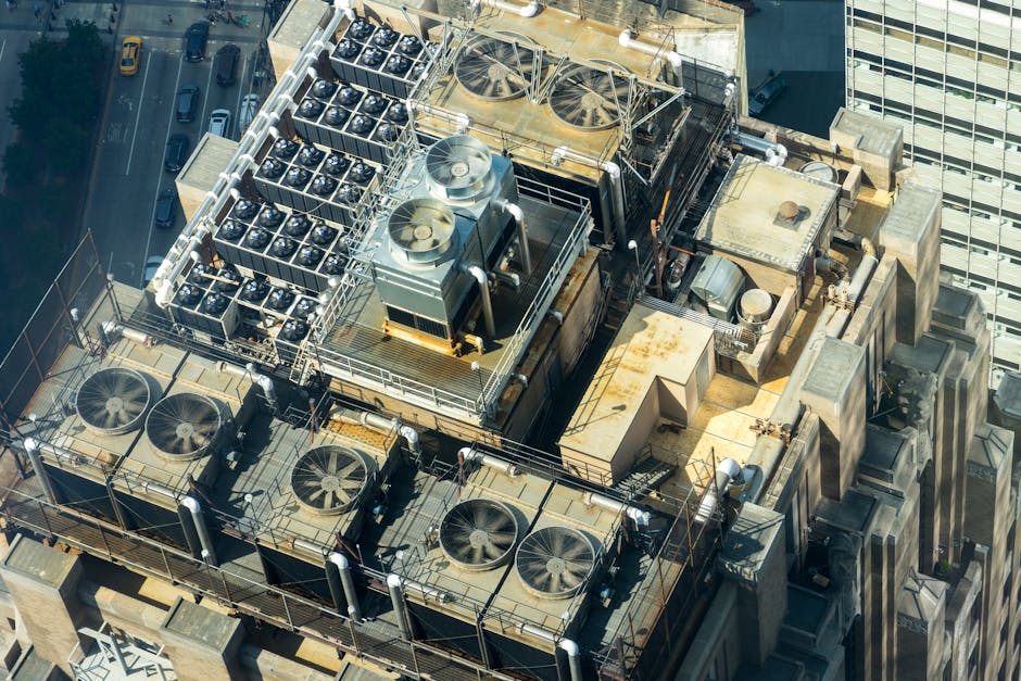 pexels-photo-2539462-2539462 High-angle shot of HVAC units on a city building's rooftop, showcasing industrial infrastructure.
